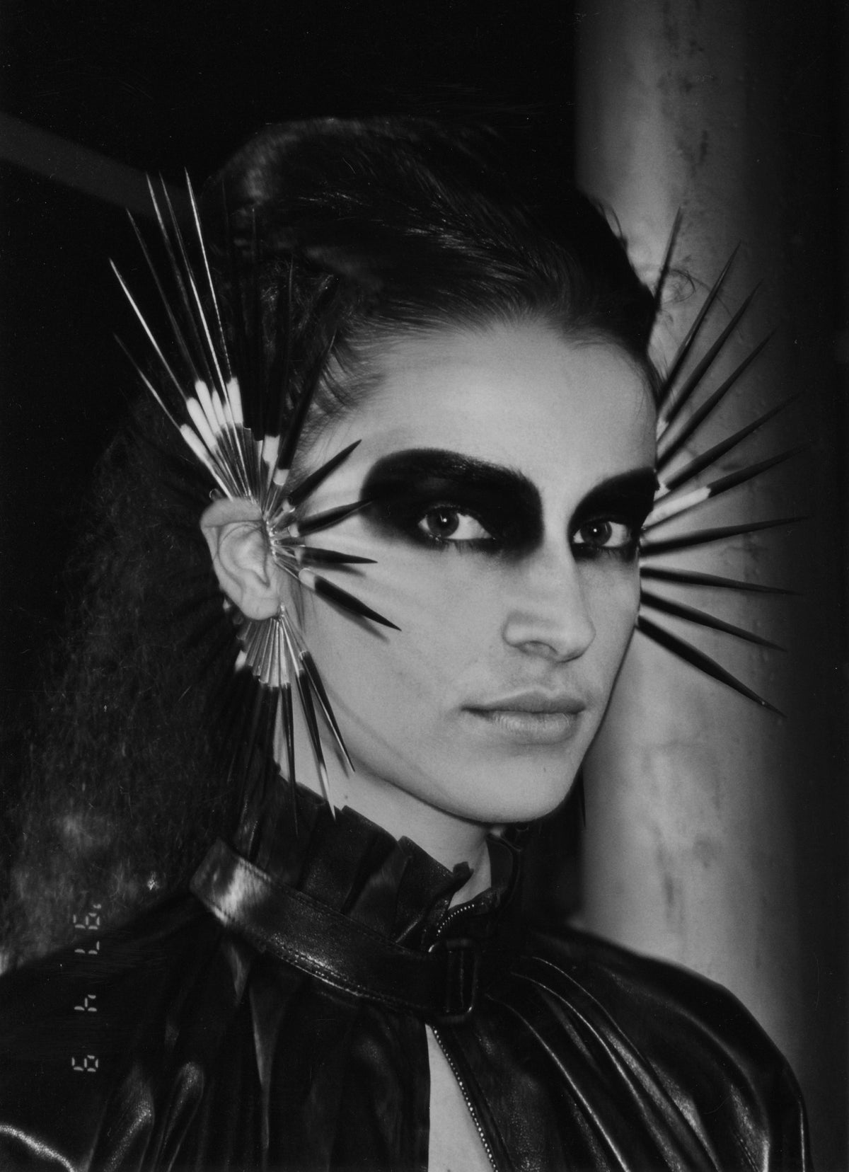 Backstage portrait from Alexander McQueen's Irere, showing a model with radiating eye adornments