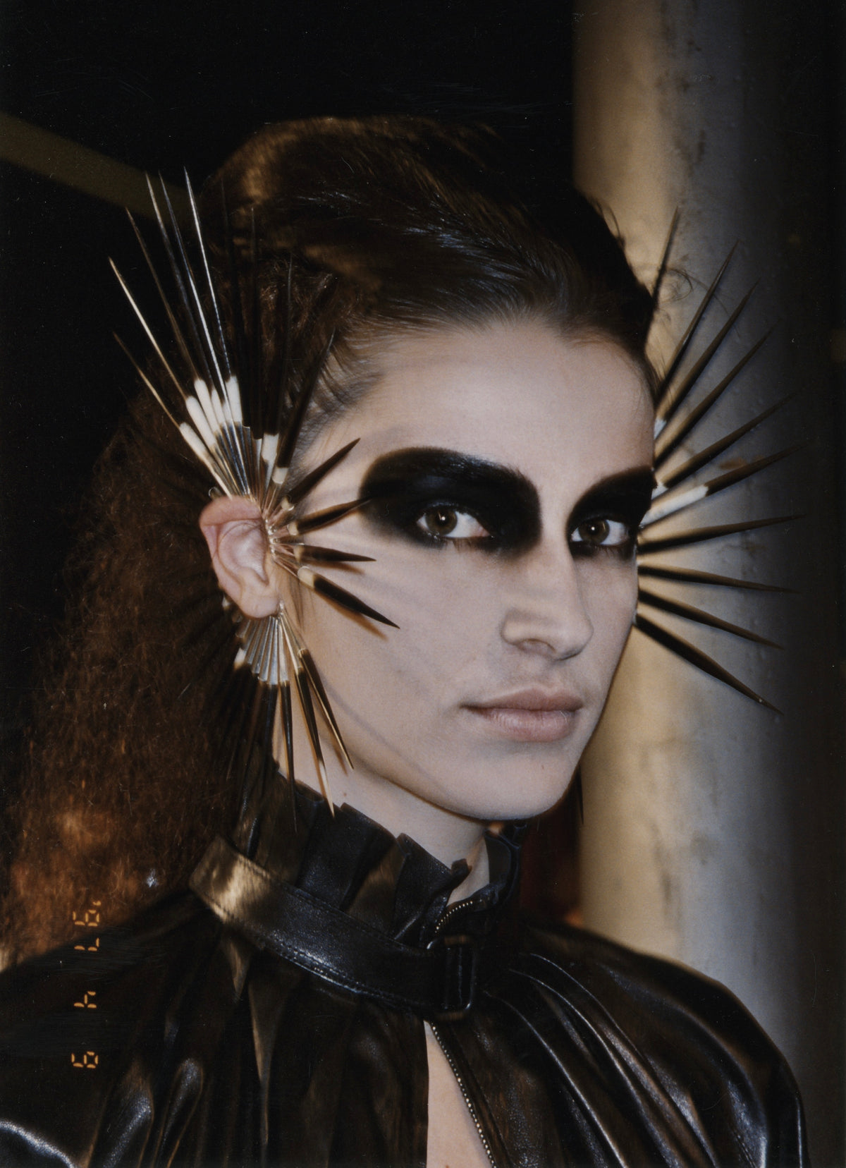 Backstage at Alexander McQueen Irere with porcupine quill ear cuffs