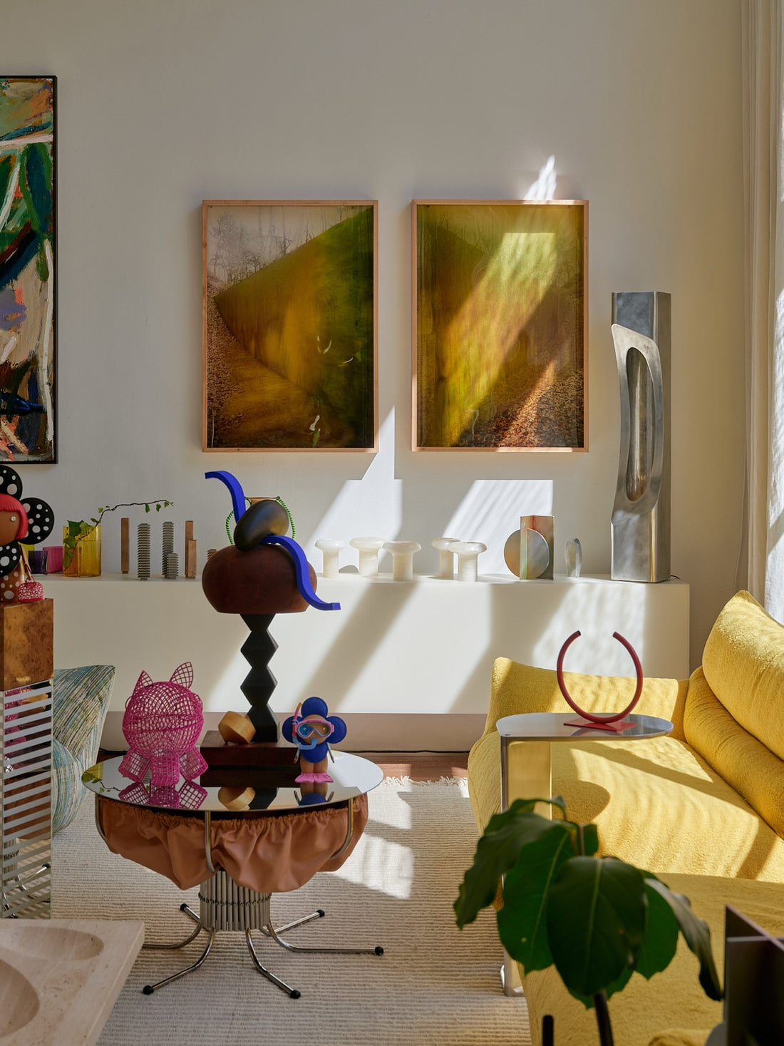 Louis Vuitton Petula and Vivienne figures among contemporary art and design beside a yellow sofa at HŌLUS BŌLUS