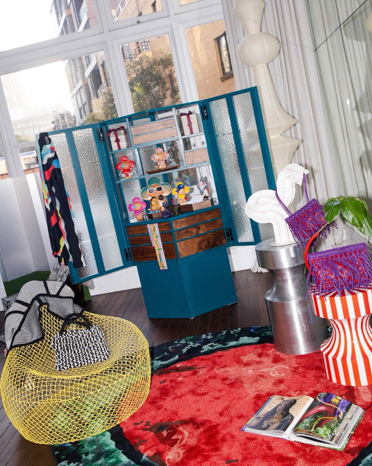 Louis Vuitton Vivienne figures supplied by Three Over Six displayed in a teal cabinet among collectible design