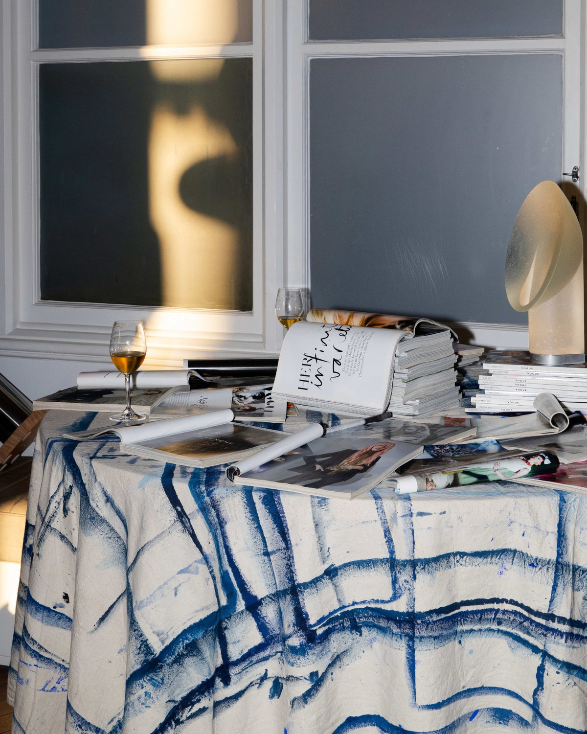 A table setting brings books, lighting and everyday objects into the exhibition.