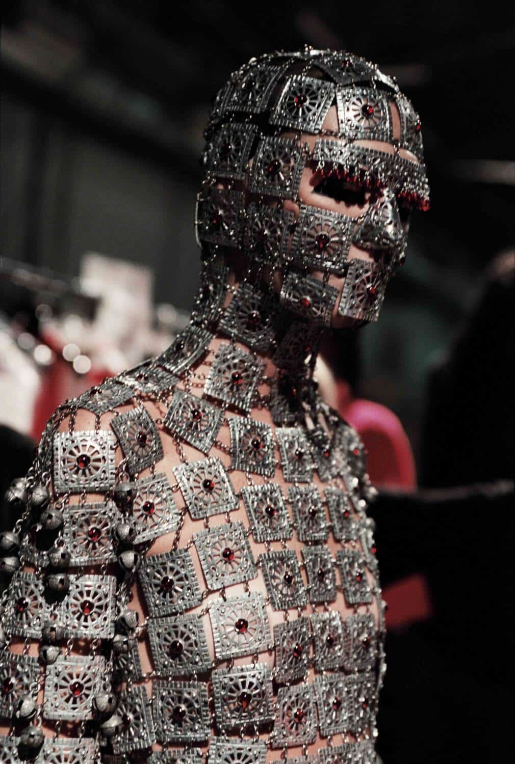 A close view of the metal plates and red stones of Shaun Leane’s Yashmak