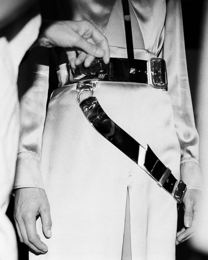 Close-up of Shaun Leane’s polished silver harness being fitted over Karen Elson’s pink satin McQueen outfit