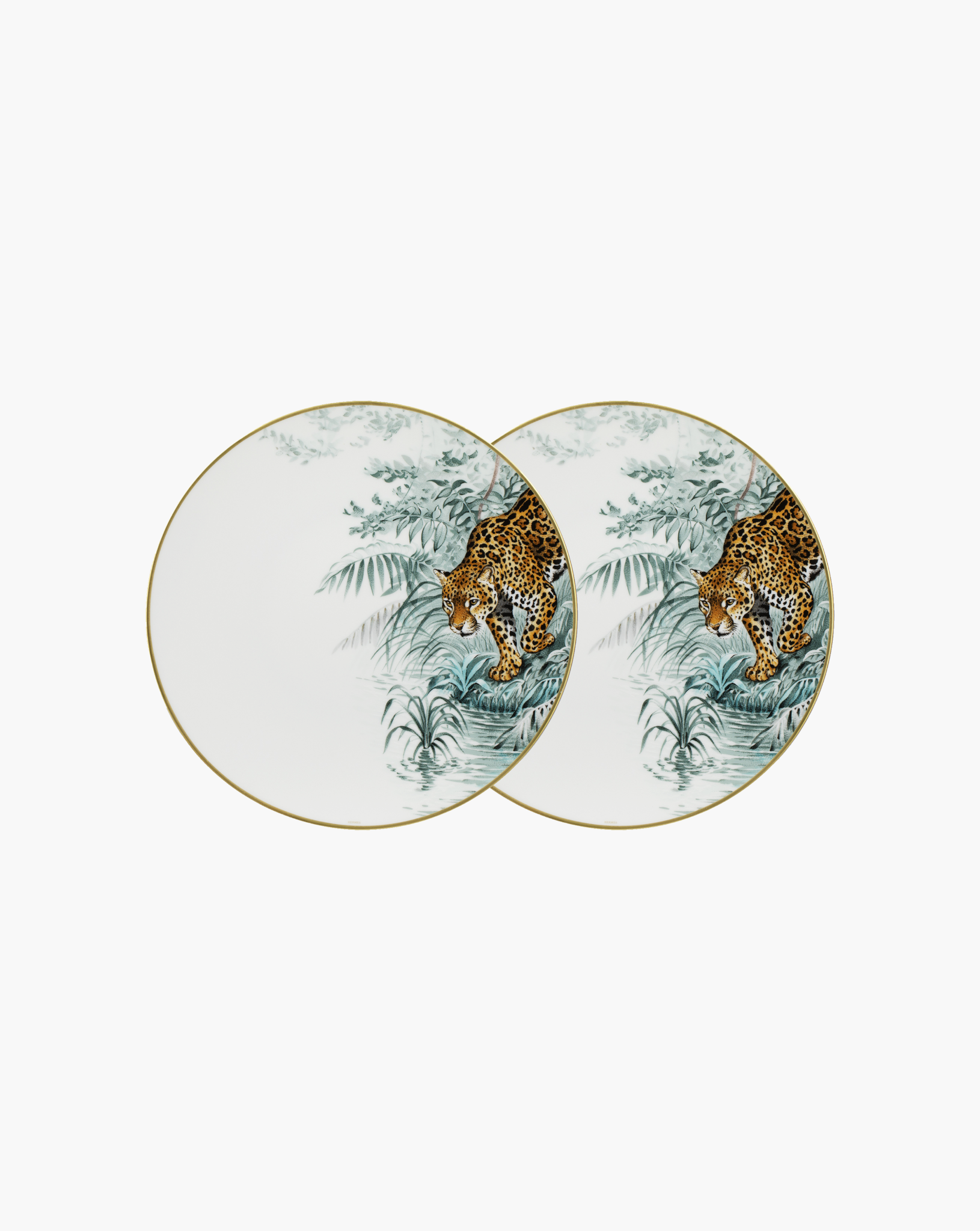 Pair of Hermès Carnets d'Équateur jaguar dinner plates on soft grey background