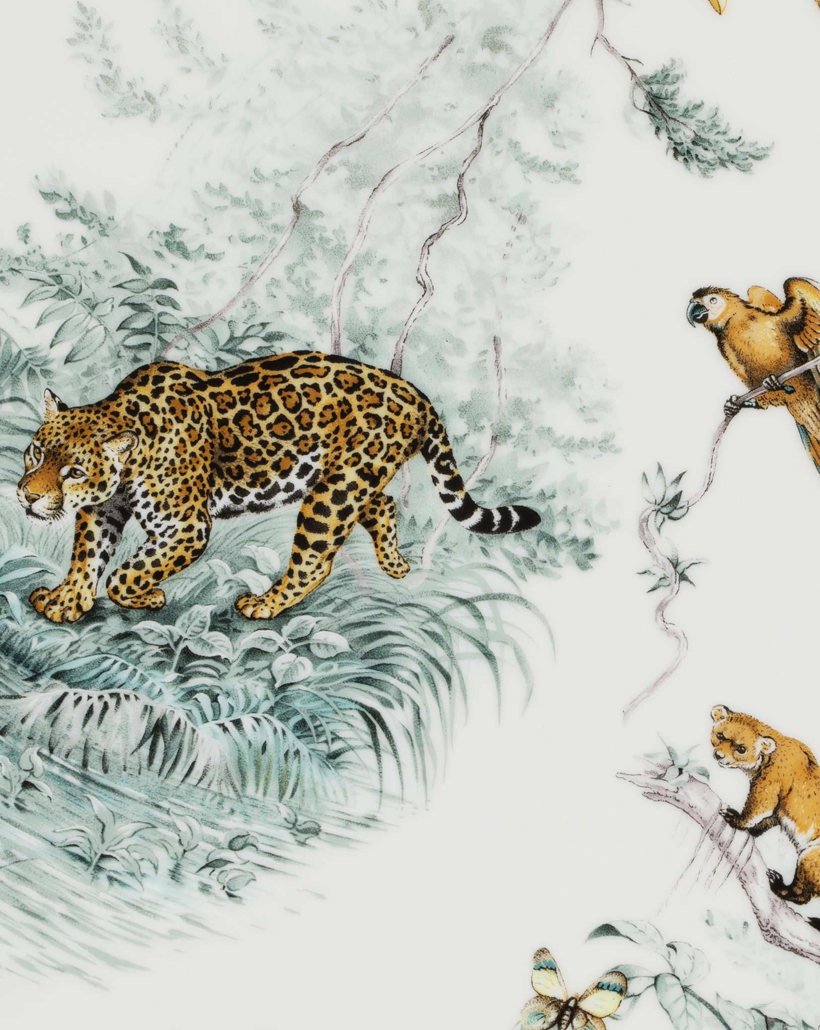 Detail of a leopard and rainforest animals on the Hermès Carnets d'Équateur large round platter