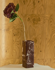 Greg Natale Celesta Vase Merlot with a burgundy hydrangea on a sculptural pedestal