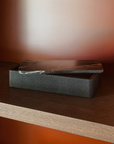 Greg Natale Palco Box Shagreen Nero with marble lid partly open on a timber shelf