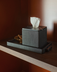 Greg Natale Palco Tissue Box and Palco Tray in Shagreen Nero on a reddish timber shelf