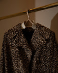 Leopard-print coat on a Lou Hansell leather-shouldered hanger