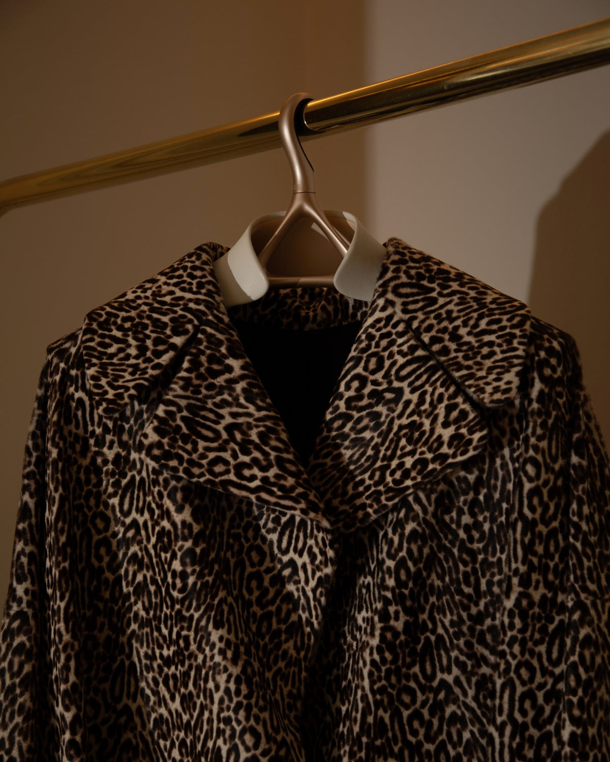 Leopard-print coat on a Lou Hansell leather-shouldered hanger