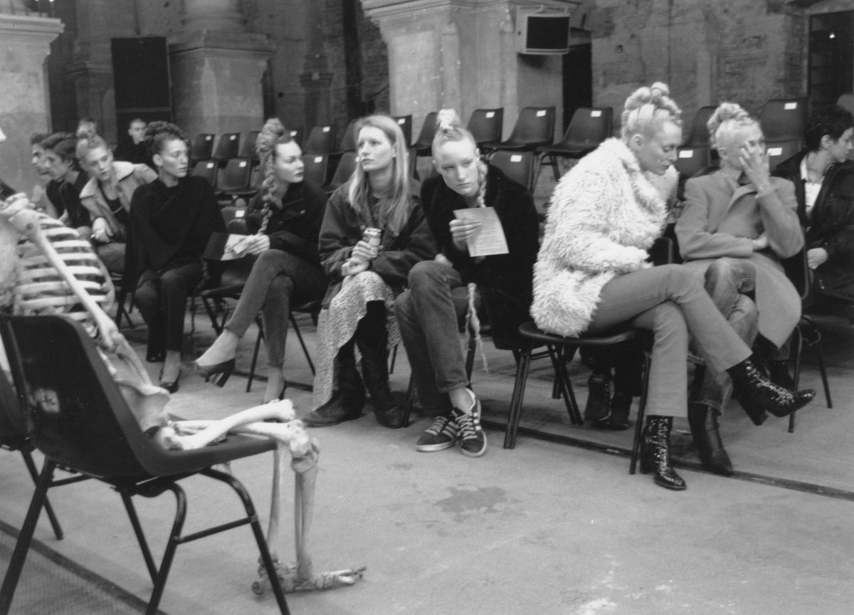 Models seated backstage before an Alexander McQueen presentation