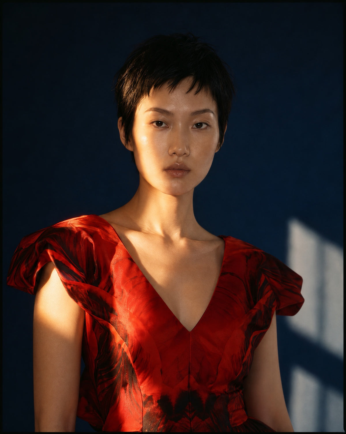 The red print and sculpted shoulders in directional light.