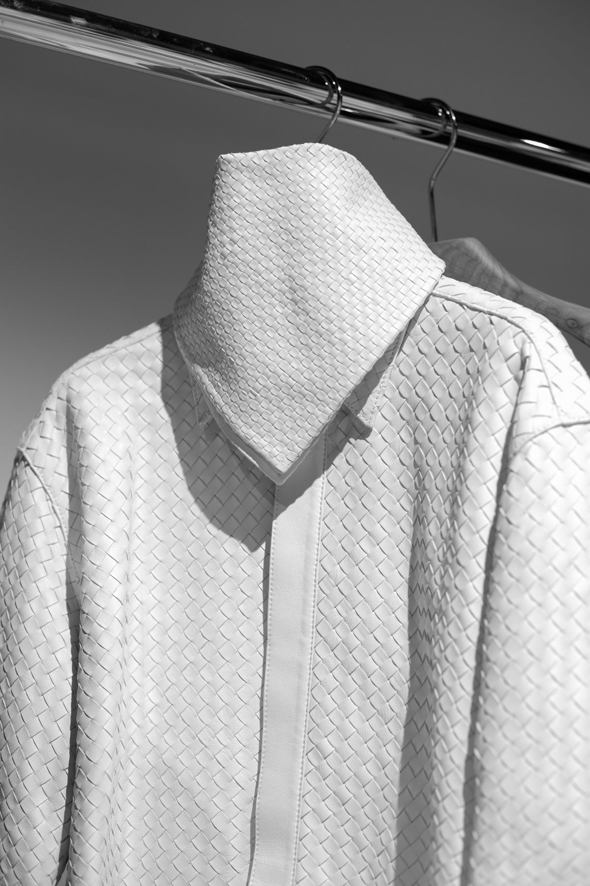 A close view of a white woven garment, photographed in black and white