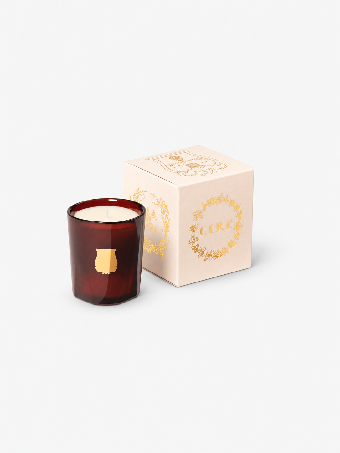 Trudon Cire Petit candle and packaging, with soft studio contact shadows.