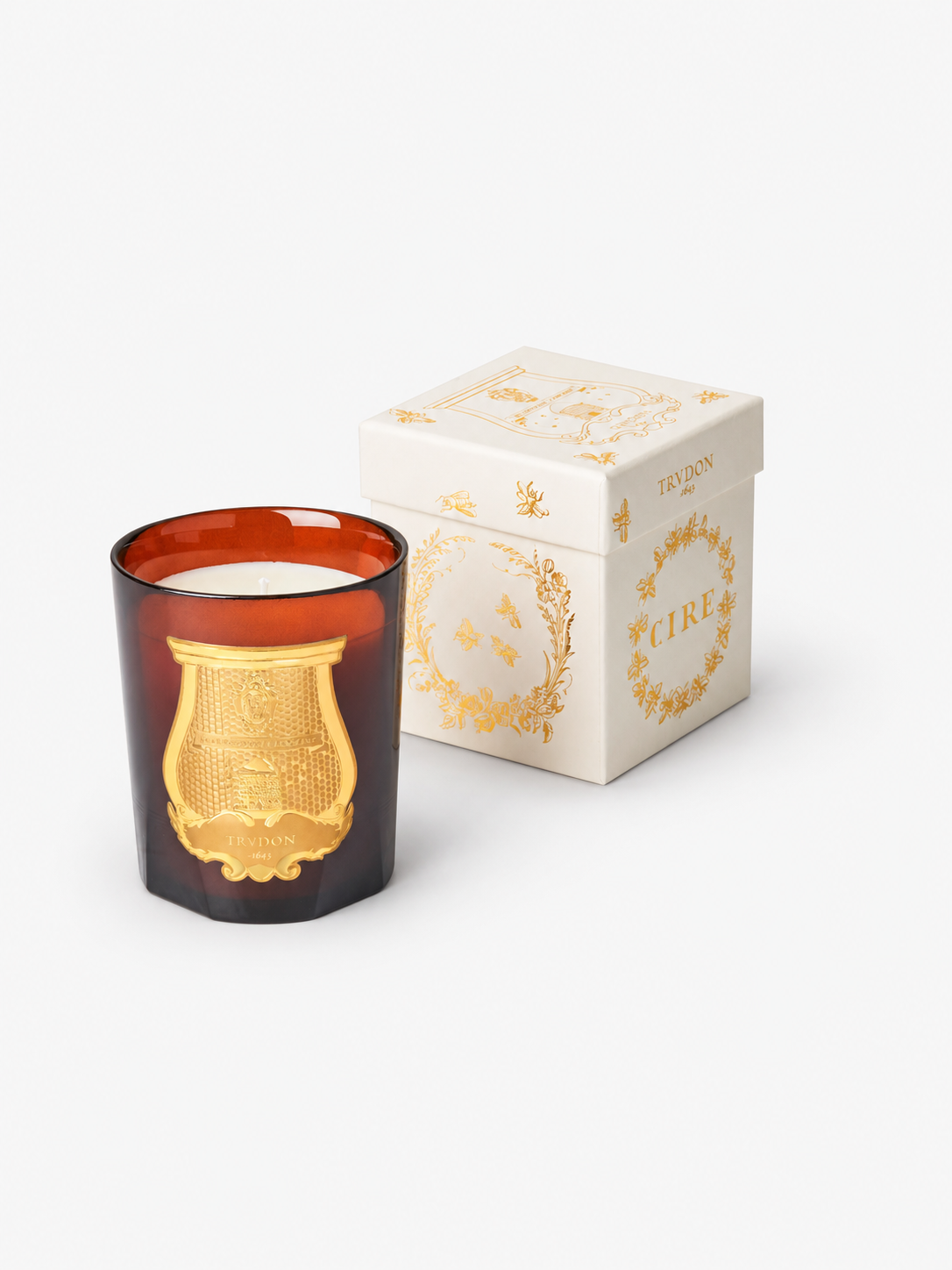 Trudon Cire Classic candle and packaging, with soft studio contact shadows.