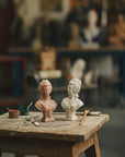 Trudon Marie Antoinette busts in pink and white on a workshop table