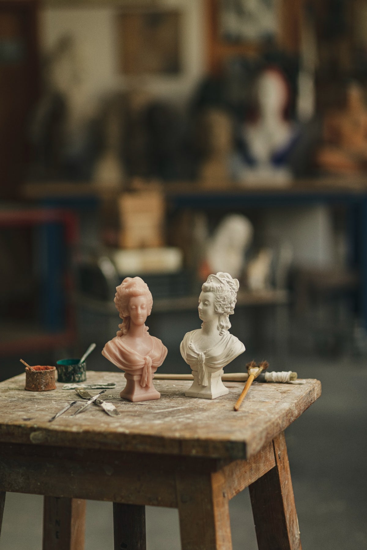Trudon Marie Antoinette busts in pink and white on a workshop table